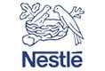 Nestlé logo featuring a bird feeding two chicks in a nest, with the word Nestlé written below in blue.