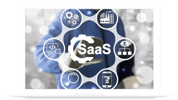 A graphic on a laptop screen displays the word SaaS surrounded by technology and software-related icons.
